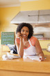 African American business owner paying bills at cafe counter