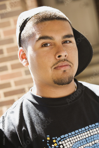 Photo: Serious Hispanic man wearing cap Serious Hispanic man wearing cap