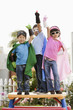 Korean children in superhero costumes with arms raised