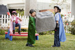 Korean children as superheros carrying large boulder