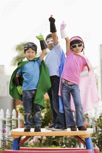 Photo: Korean children in superhero costumes with arms raised Korean children in superhero costumes with arms raised