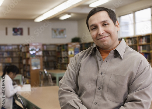 Photo: Mixed race librarian in school library Mixed race librarian in school library
