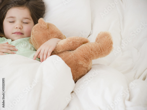 Photo: Mixed race girl sleeping with teddy bear Mixed race girl sleeping with teddy bear