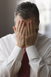 Caucasian businessman with hands over face