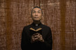 Pacific Islander priest praying