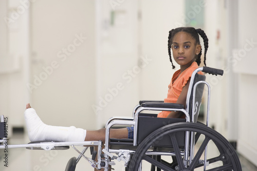 Photo: African American girl with broken leg sitting in wheelchair African American girl with broken leg sitting in wheelchair