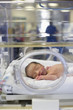 Hispanic baby asleep in intensive care unit