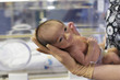 Nurse holding baby in intensive care unit