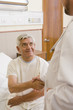 Doctor shaking patient’s hand in hospital room