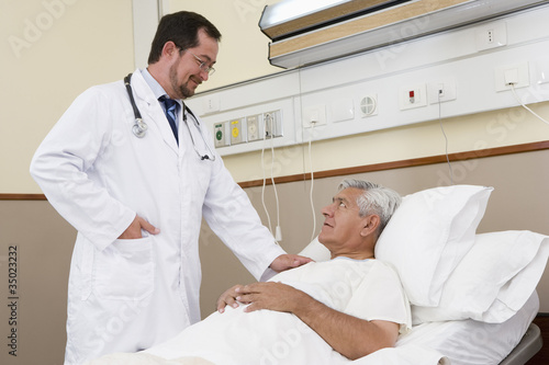 Photo: Doctor talking with patient in hospital Doctor talking with patient in hospital