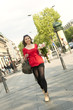 Caucasian woman walking and holding bouquet
