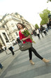 Caucasian woman walking and holding bouquet