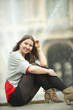 Caucasian woman sitting near fountain