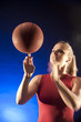 Caucasian woman spinning basketball