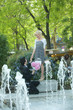 Caucasian man proposing to girlfriend near fountain
