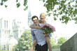 Caucasian man giving girlfriend piggyback ride near Notre Dame