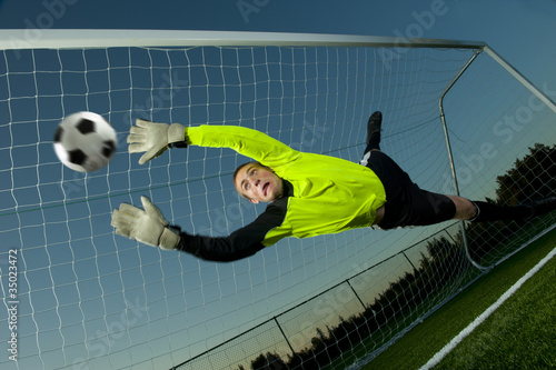 Photo: Caucasian goalie deflecting soccer ball Caucasian goalie deflecting soccer ball