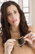 Mixed race woman opening empty coin purse