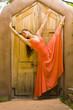 Hispanic woman dancing near door
