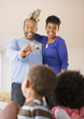 Black parents photographing children