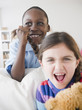 Photo: Grinning boy pulling girls braid Grinning boy pulling girls braid