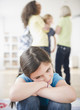 Photo: Lonely girl ignoring friends playing Lonely girl ignoring friends playing