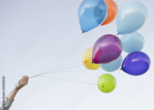 Photo: Caucasian woman holding bunch of balloons Caucasian woman holding bunch of balloons