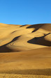 Blue sky and desert sand dunes