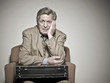 Sad Caucasian businessman sitting in chair