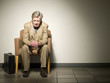 Sad Caucasian businessman sitting in chair