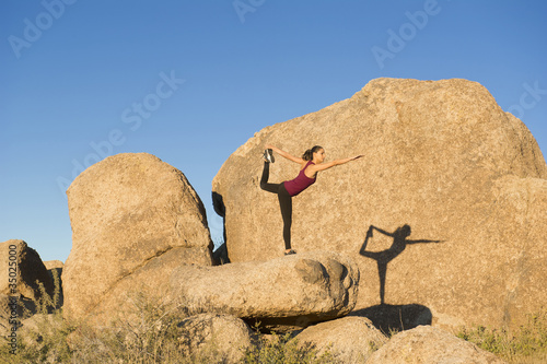 Photo: Hispanic woman practicing yoga on rock Hispanic woman practicing yoga on rock