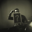 Man holding question mark on chalk board