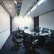 Empty conference room with discarded papers