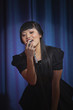 Elegant Asian woman singing into microphone