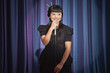 Elegant Asian woman singing into microphone