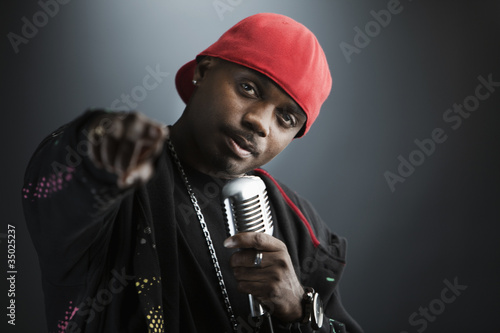 Photo: Serious Black man holding microphone and pointing Serious Black man holding microphone and pointing