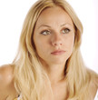 Beautiful blond girl with serious expression, isolated