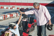 Hispanic grandfather and grandson on go-cart track