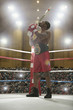 African American kissing trophy in boxing ring