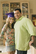 Father standing with daughter wearing graduation cap