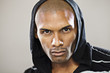 Serious Hispanic man wearing hoody