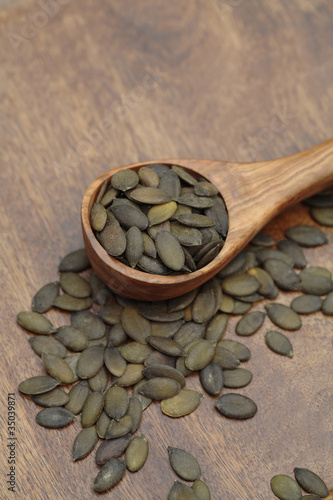 Photo: Close up of toasted pumpkin seeds in wooden spoon Close up of toasted pumpkin seeds in wooden spoon