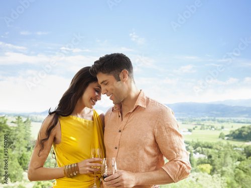 Photo: Couple drinking cocktails and hugging Couple drinking cocktails and hugging