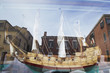 Wooden ship model behind glass