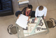 Architects reviewing building model in office