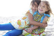 Children hugging on beach