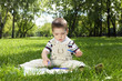 Portrait of a boy with a book in the park