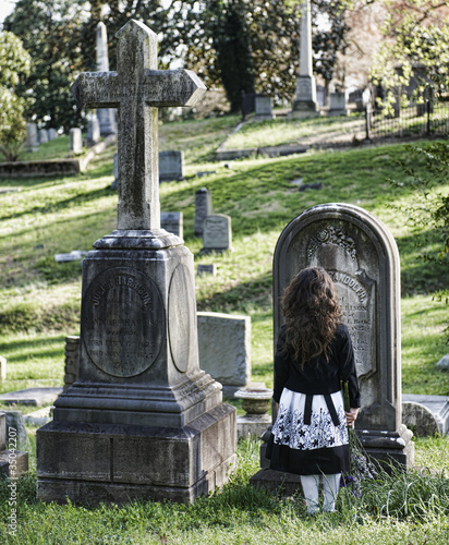Photo: Hispanic girl visiting cemetery Hispanic girl visiting cemetery