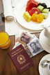 Chinese passport and money on breakfast table