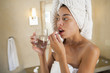 Mixed race woman taking vitamins in the morning